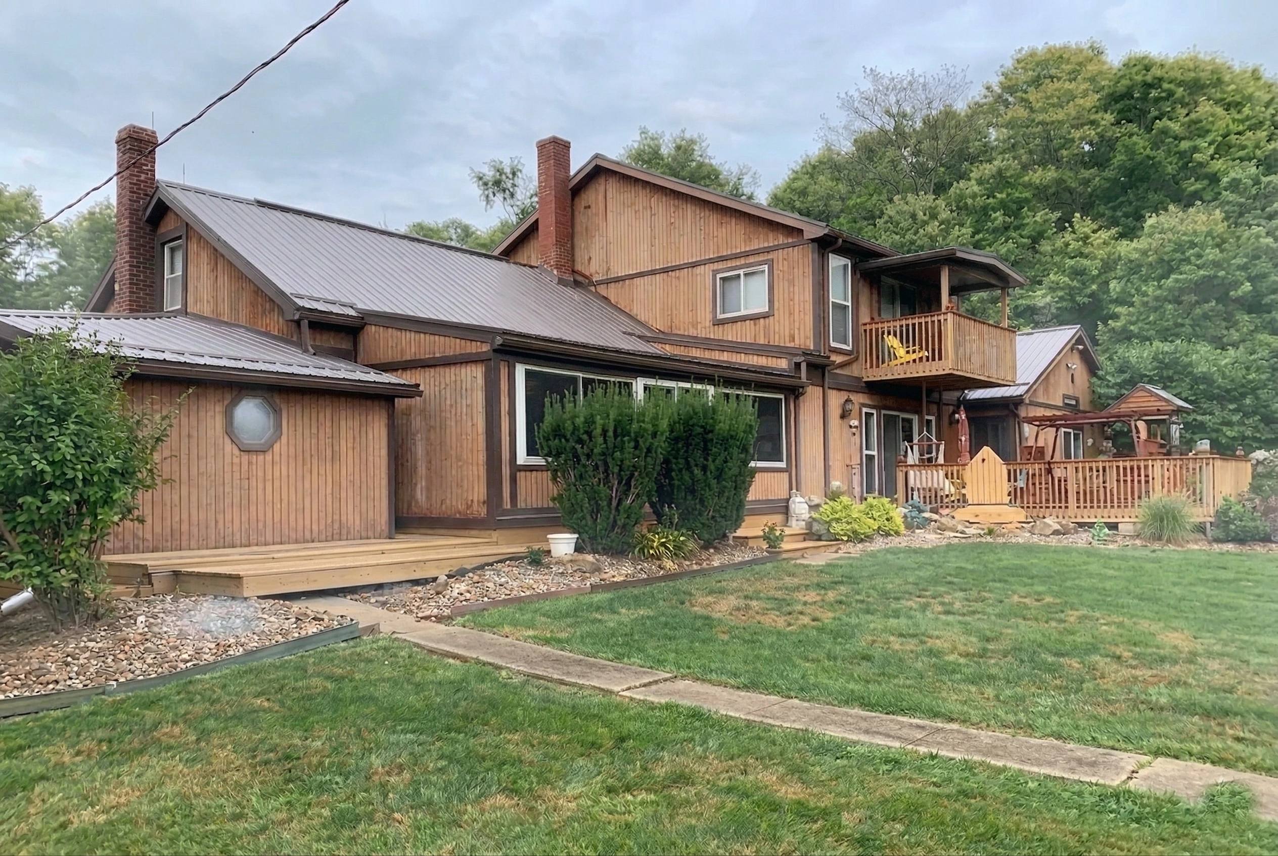 Home with aging wood siding before TruLog installation