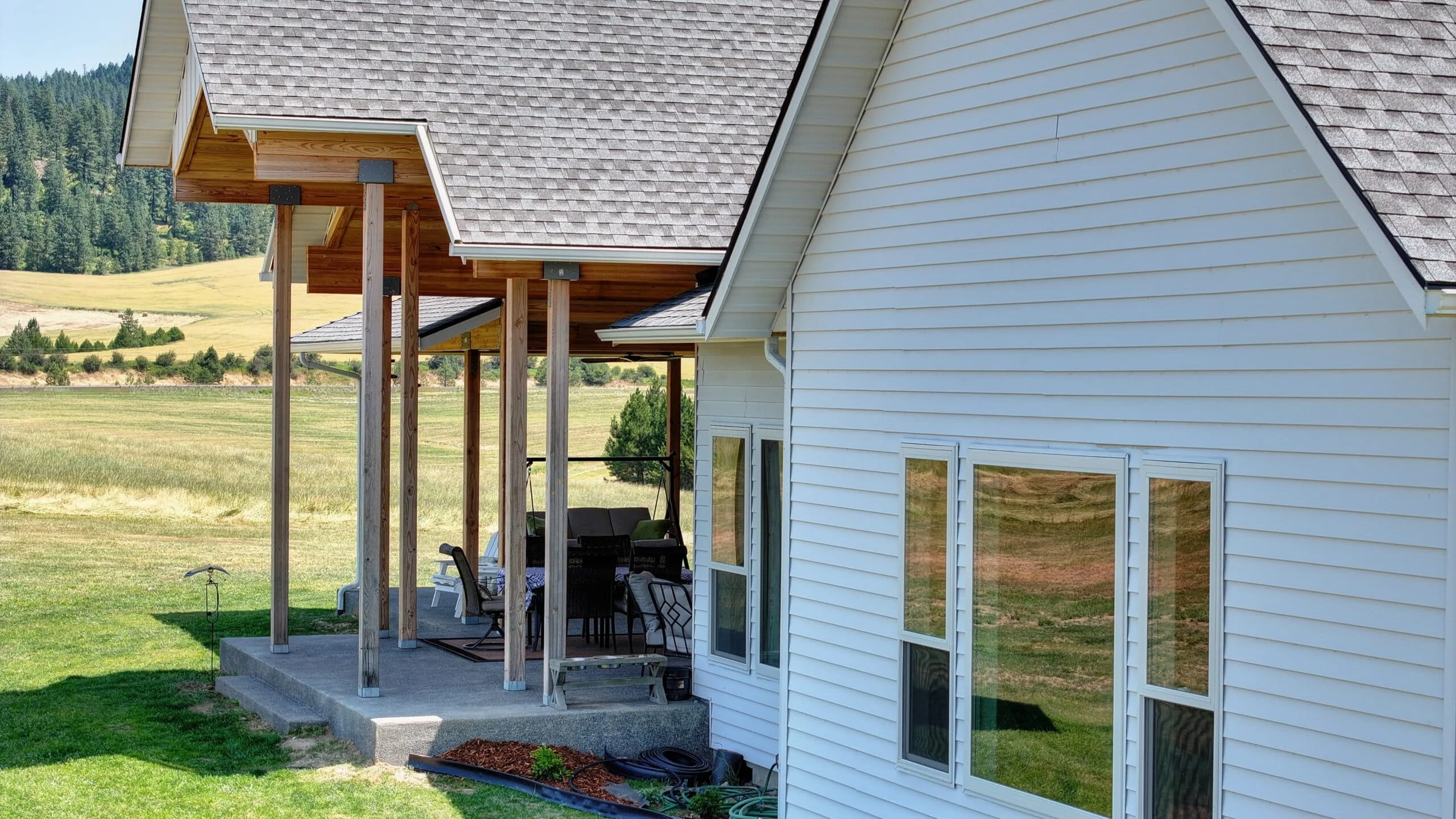 White colonial-style home with TruLog steel lap siding