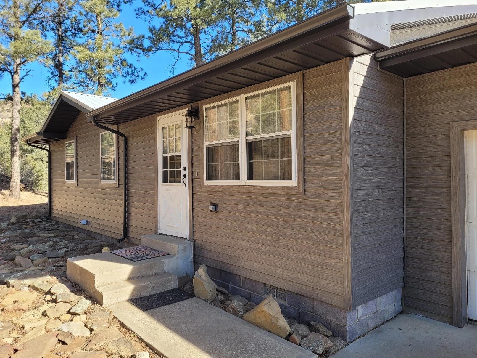 Home exterior with TruLog steel lap siding in driftwood finish