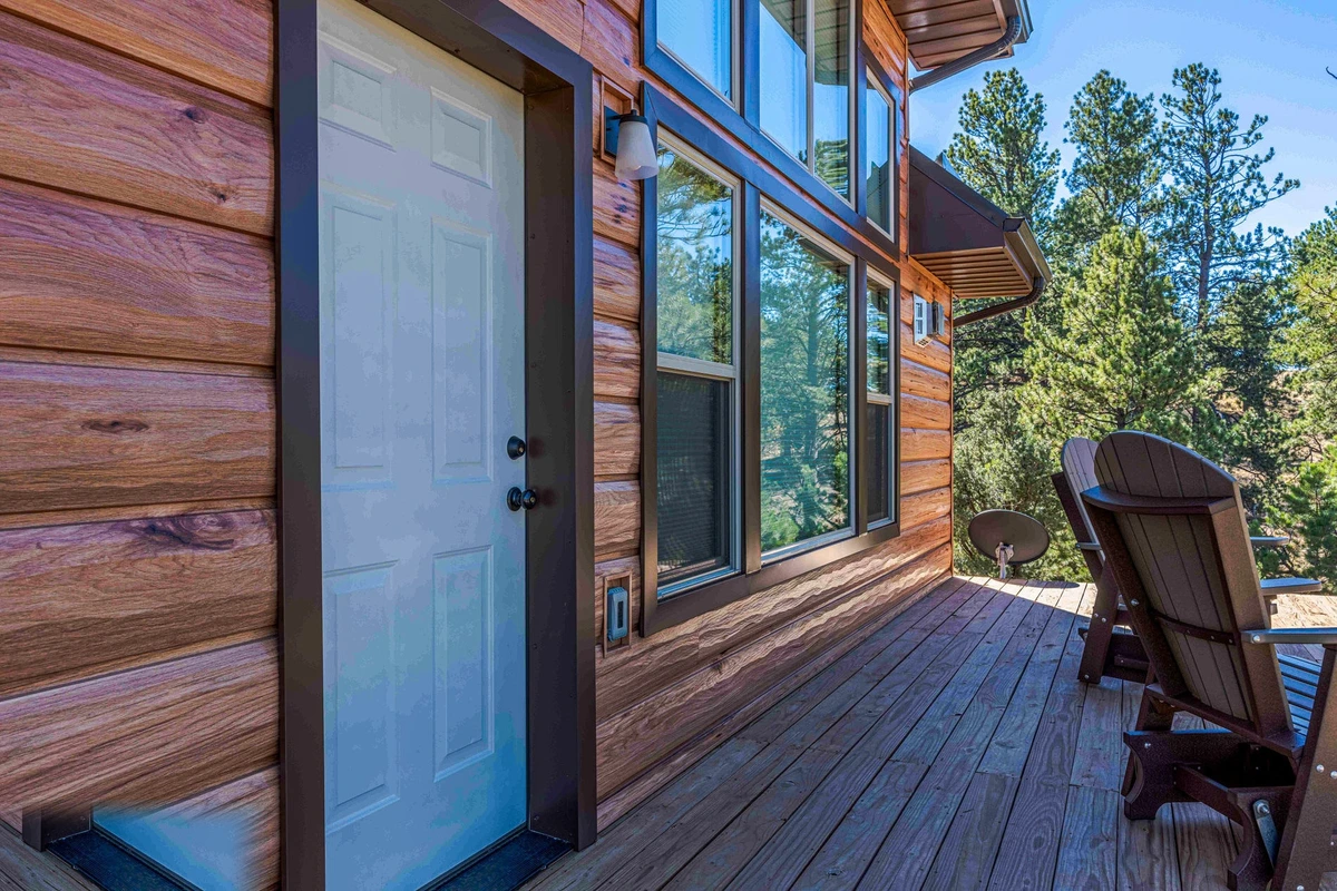 Hickory log siding porch with warm amber woodgrain