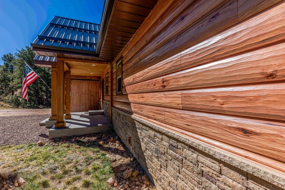 Home with TruLog Hickory steel log siding and American flag