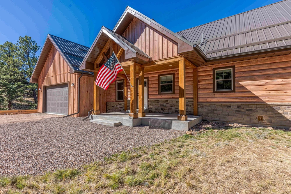 Mountain home with TruLog Hickory log siding and wraparound porch